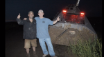 The crew poses next to the TIV2, which was caked in mud by the tornado.